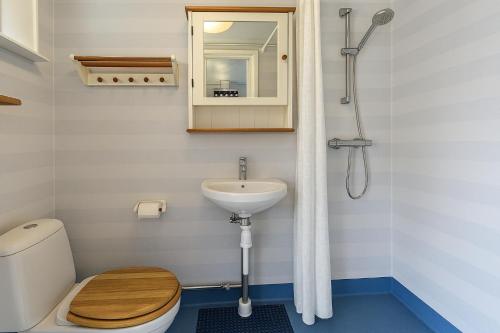 a bathroom with a toilet and a sink at Cozy Studio on Utö Near Beach & Restaurant in Utö