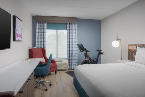 a hotel room with a bed and a desk and chair at Hilton Garden Inn Abilene in Abilene