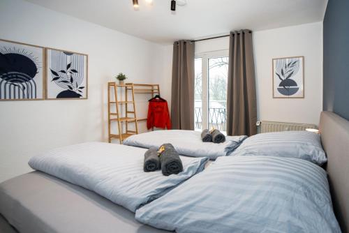 two beds with stuffed animals laying on them in a bedroom at Quartier VierGlück in Marl