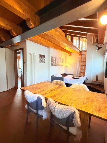 a large wooden table with chairs in a room at Maison Poluc - Maison Monte Rosa in Champoluc
