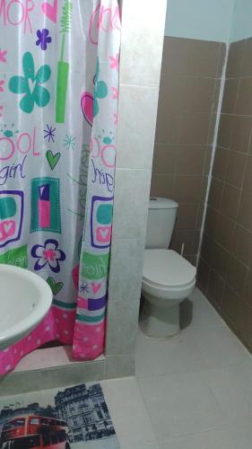 a bathroom with a toilet and a shower curtain at punta bolivar in San Antero