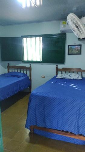 a room with two beds and a green board at punta bolivar in San Antero