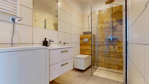 a white bathroom with a shower and a toilet at Studio Fibra Macchiato in Rybnik