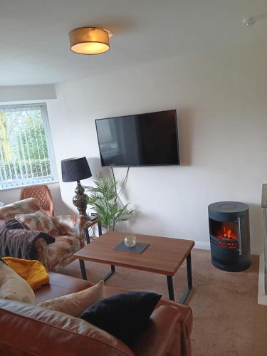 a living room with a couch and a fire place at The Studio in Windermere