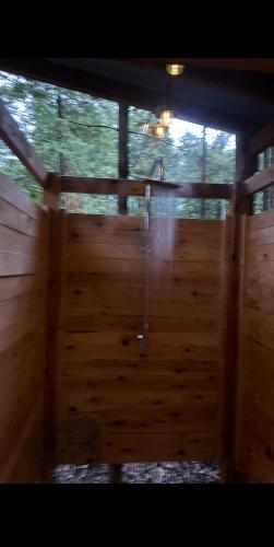 an inside view of a wooden room with a shower at Rustic cozy couples summer stay in Little Current