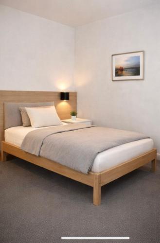a bedroom with a large bed with a wooden frame at Villa Amarone in Mannheim