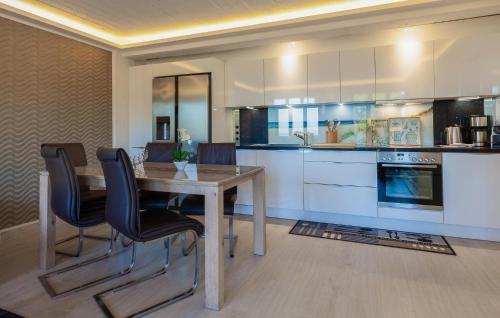 a kitchen with a table and chairs in a room at Eden in Binz