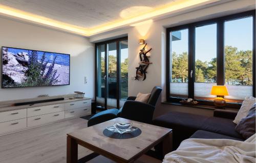 a living room with a couch and a tv at Eden in Binz