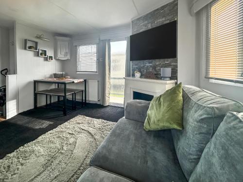a living room with a couch and a fireplace at Emily's Van in Skegness