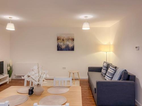 a living room with a couch and a table at 58c Thorpe Road - City Centre in Norwich