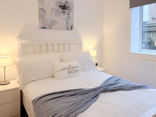a bedroom with a white bed with a pillow on it at 58c Thorpe Road - City Centre in Norwich