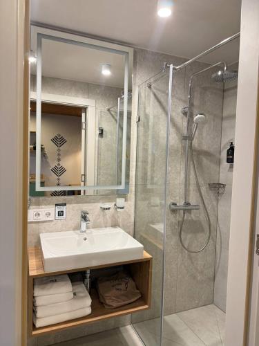 a bathroom with a sink and a shower at Drevny Grad Park-hotel in Lviv