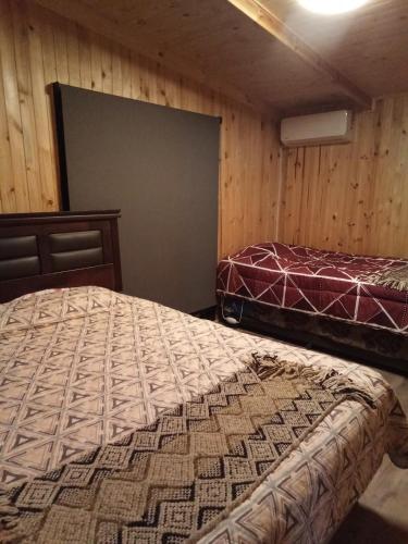 a bedroom with two beds and a projection screen at Casa Hostal Familiar Espacio SaTaNaMa in El Torreón