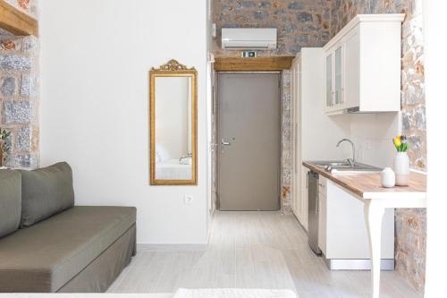 a living room with a couch and a sink and a mirror at Elaianthos 2 in Gythio