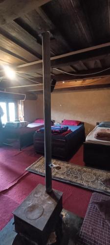 a room with bunk beds and a pole in the floor at Roohi in Nagar