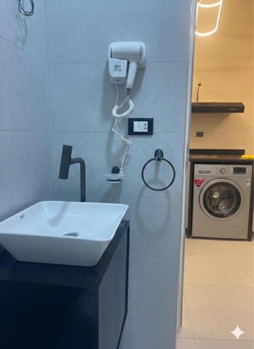 a bathroom with a sink and a washing machine at Younis chalet in Dahab