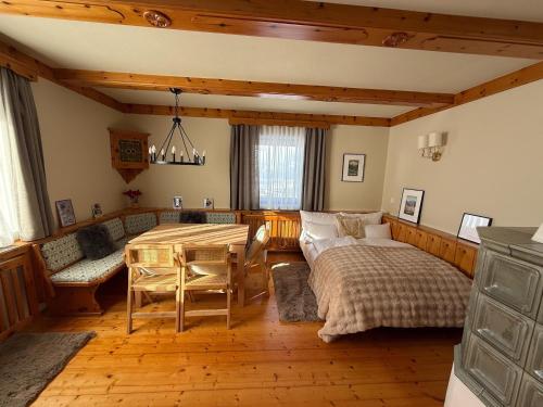 a living room with a bed and a table at Holiday home with panoramic views in Tulfes