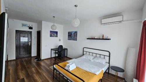 a bedroom with a bed and a wooden floor at Luca Apartament in Bucharest