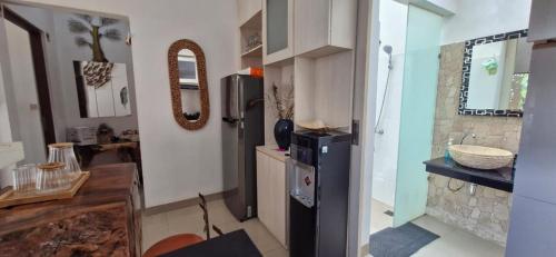 a kitchen with a black refrigerator and a counter at Cozy 1Bedroom House with Kitchen Work Space in Nusa Dua