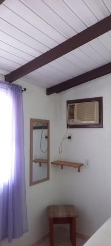 a bedroom with a ceiling with a mirror and a window at Espaço da paz in Joinville