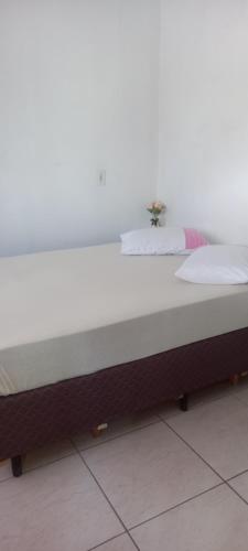 a large white bed sitting in a room at Espaço da paz in Joinville
