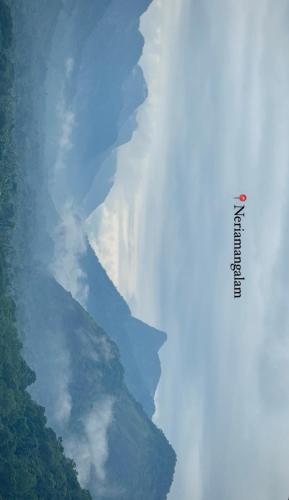 a view of a river with clouds in the sky at The EDGE Paradise in Neriyamangalam