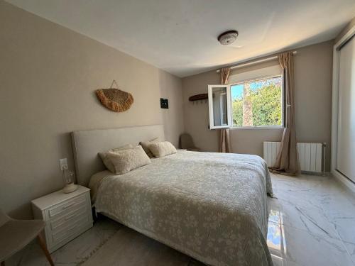 a bedroom with a bed and a window at Casa MaJa in Denia