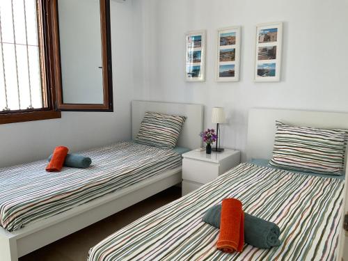 two twin beds with pillows in a room at Gound Floor Bungalow Jumilla III Playa Flamenca in Orihuela Costa
