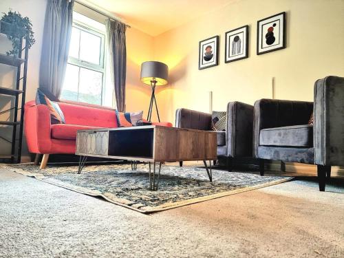 a living room with couches and a coffee table at Spacious 4 Bed Family Home with Private Garden & Free Parking - Hamilton in Leicester