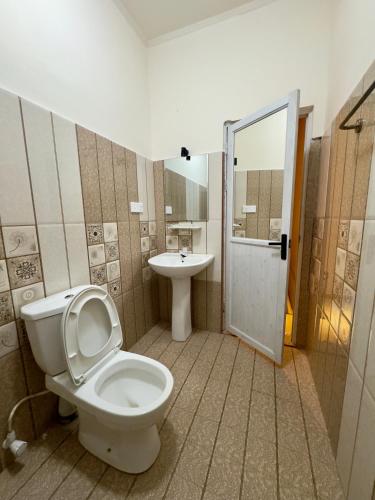 a bathroom with a toilet and a sink at THC - Tropical Hideaway Ceylon in Talpe