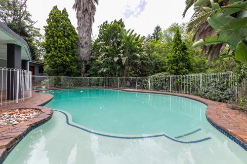 a swimming pool with a fence around it at Mistica on St James in Johannesburg