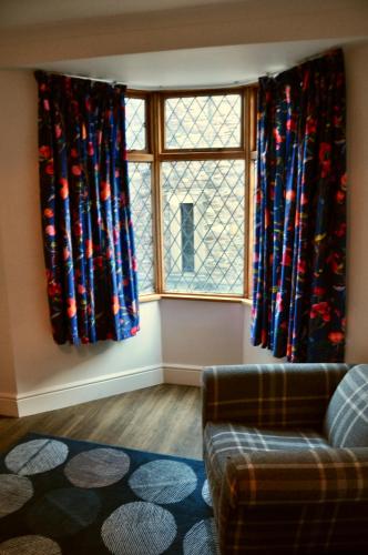 a living room with a couch and a window at Ash Cottage - Caerleon in Newport