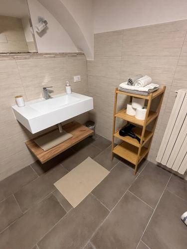 a bathroom with a white sink and a shower at Il vicoletto in Sulmona