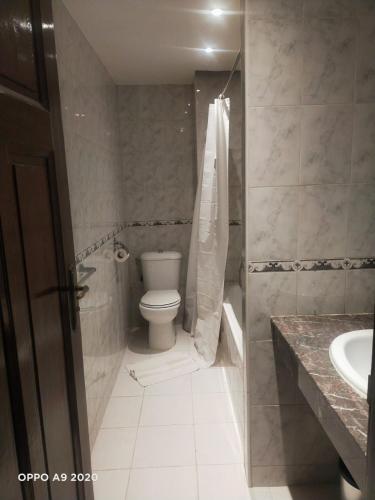 a bathroom with a toilet and a sink at Royal Hotel Rabat in Rabat