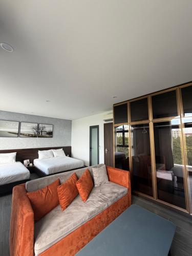 a living room with a couch and two beds at Tom Tom Homestay in Phú Quốc