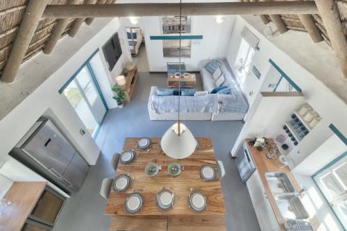 an overhead view of a living room with a table at Cape Creek Cottage, Luxury Coastal Getaway in Struisbaai