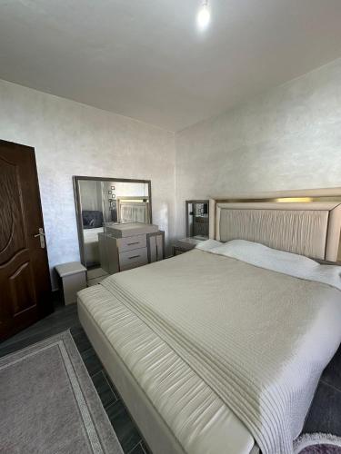 a bedroom with a large bed and a mirror at Darona Apartments - Nablus in Nablus