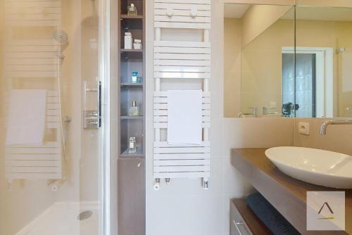 a bathroom with a sink and a shower at Le Palais du Commerce in Rennes