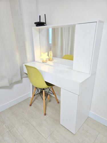 a white desk with a yellow chair in a room at Haven 10 HOUSE in Seoul