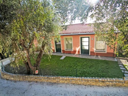 a small house with a tree in front of it at Apartment Borgoverde-5 by Interhome in Imperia