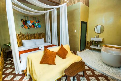 a bedroom with a bed and a tub in it at Ruby's Home- Doc Let's House in Ngân Hà