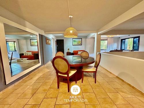 a dining room with a table and chairs at Canto das Praias - Florianópolis/SC in Florianópolis