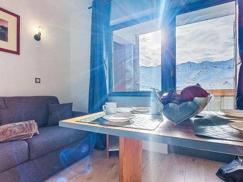 a living room with a table and a couch at Studio Les Olympiades-28 by Interhome in Val Thorens