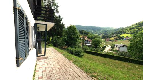 a balcony of a house with a view of a valley at Kuća za odmor Trnac in Tuhelj