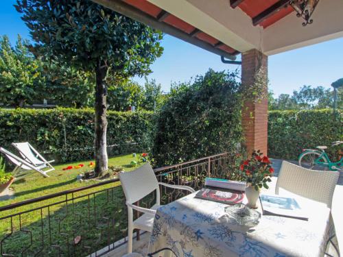 a patio with a table and chairs and a garden at Villa Patrizia by Interhome in Forte dei Marmi