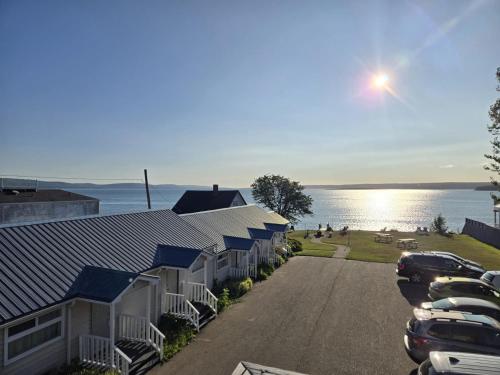 a row of houses with cars parked in a parking lot at Seawinds Motel & Suites in Digby