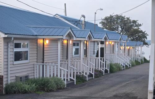 a row of white houses with blue roofs at Seawinds Motel & Suites in Digby