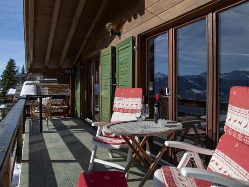 a patio with a table and chairs on a balcony at Chalet 5 Ecorces by Interhome in Verbier