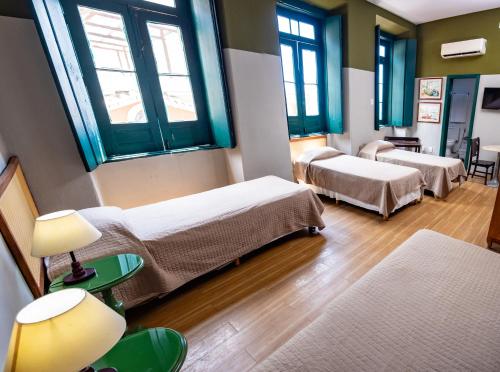 a hospital room with two beds and two windows at Pousada Colonial Chile in Salvador
