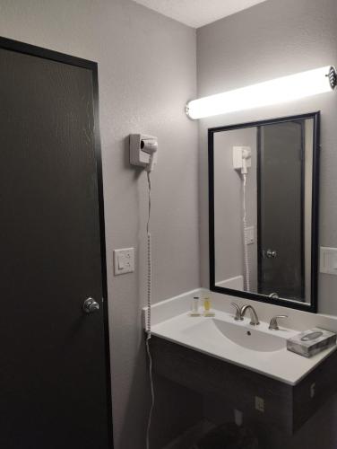 a bathroom with a sink and a mirror at Super 8 by Wyndham Morris in Morris